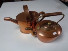 An antique copper and brass teapot together with a copper watering can.