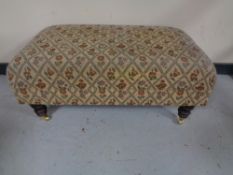 An oversized footstool in tapestry fabric, 93 x 52 x 42 cm.