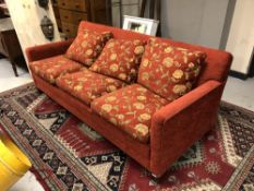A three seater settee in floral fabric