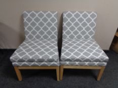 A pair of contemporary bedroom chairs upholstered in grey and white fabric