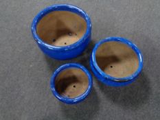 A set of three graduated glazed pottery planters (blue)