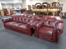 A burgundy leather buttoned leather three seater settee and armchair