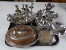 A tray containing plated wares to include terrenes, pair of three way candlesticks, goblets etc.