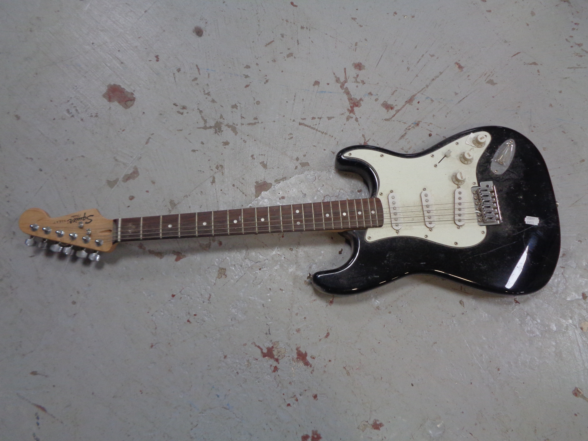 A Squier by Fender Strat electric guitar.