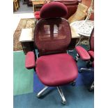 An ergonomic adjustable high backed office chair with head rest in purple mesh fabric