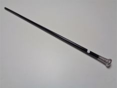 A walking cane with silver pommel