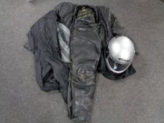 An MDS motorcycle helmet together with a set of motorcycle leathers and a waterproof suit