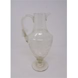 An antique etched glass jug,