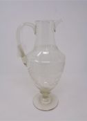An antique etched glass jug,