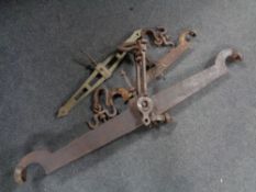 Three antique balance scale arms (two wrought iron,