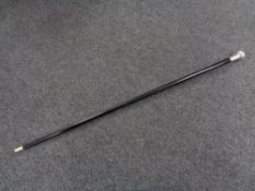 A walking cane with silver pommel