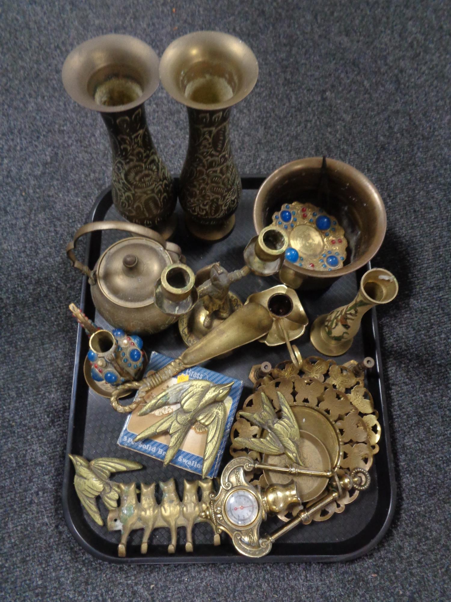 A tray containing assorted brass ware to include Eastern brass vases, two way candlestick,