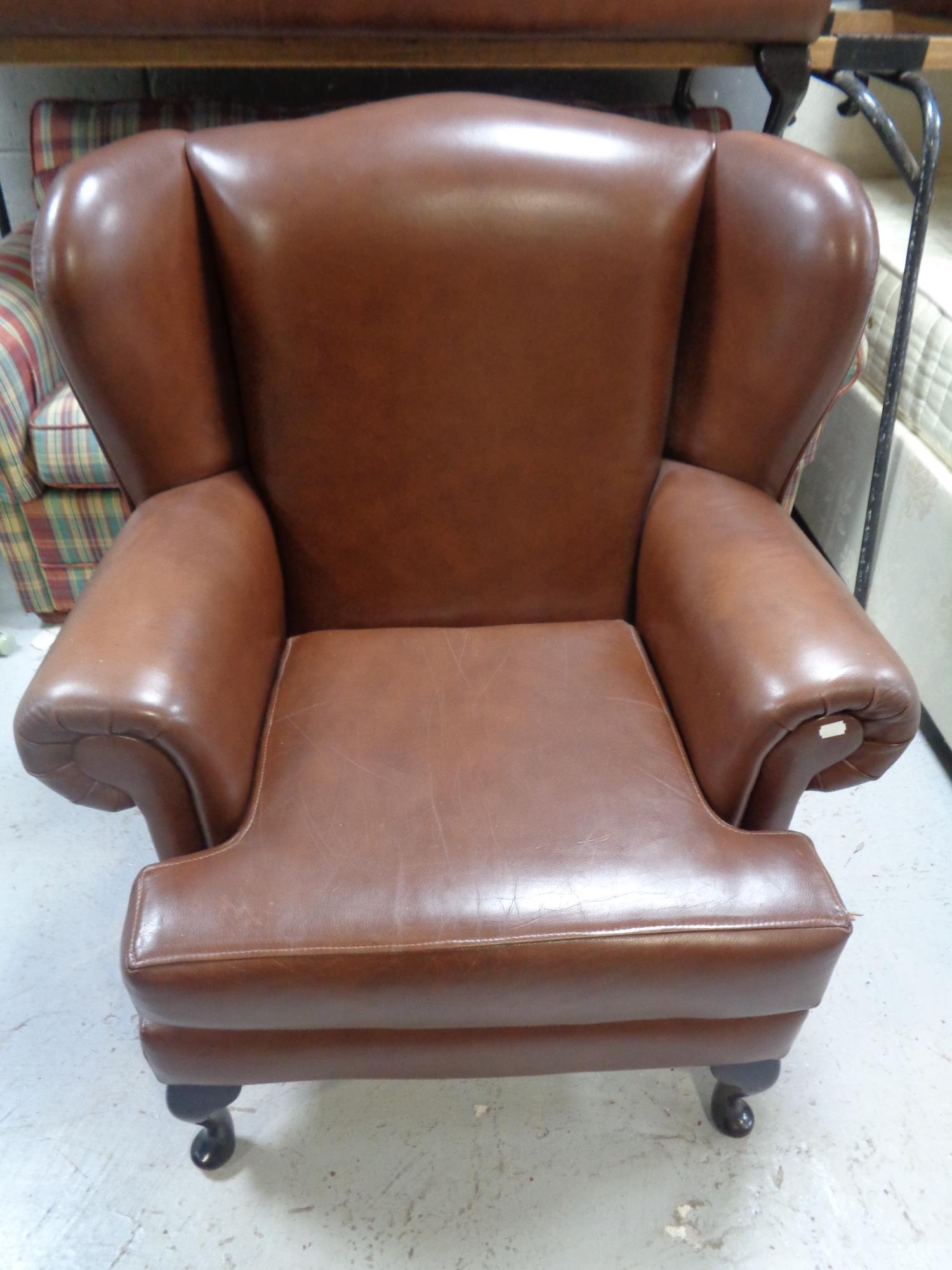 A brown leather three piece lounge suite comprising of wing backed settee and pair of armchairs - Image 2 of 2
