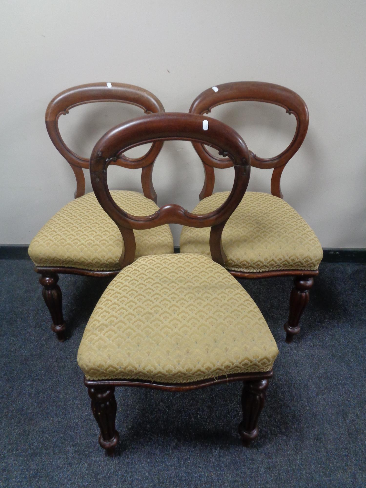 A set of three Victorian mahogany balloon backed chairs