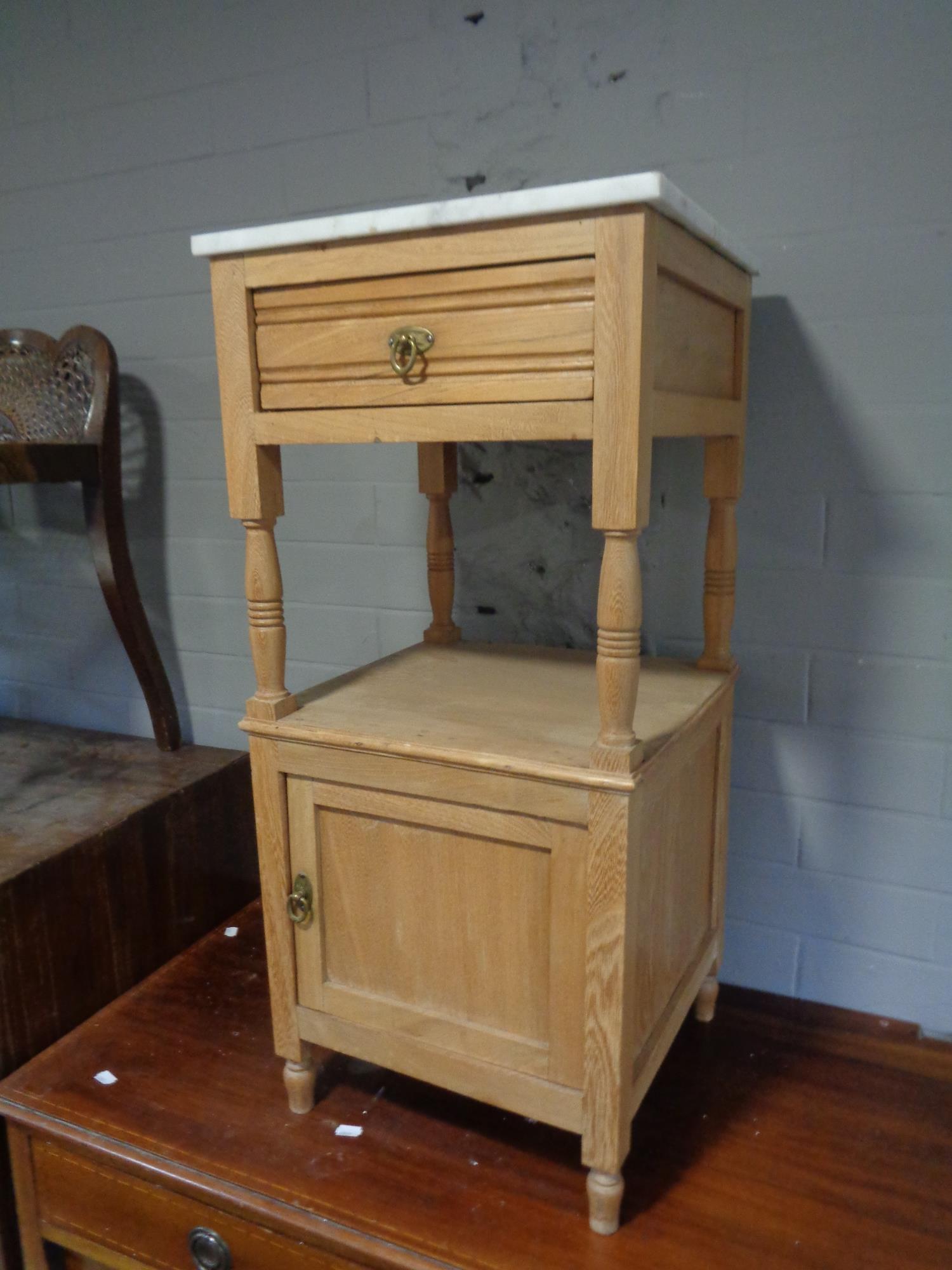 An antique pine marble topped bedside table fitted a drawer
