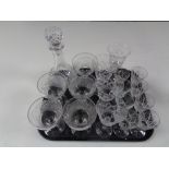 A tray containing assorted drinking glasses, decanter with stopper.