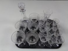 A tray containing assorted drinking glasses, decanter with stopper.