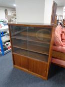 A mid century sliding glass door bookcase