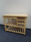 A pine kitchen butcher's block trolley fitted with drawers,