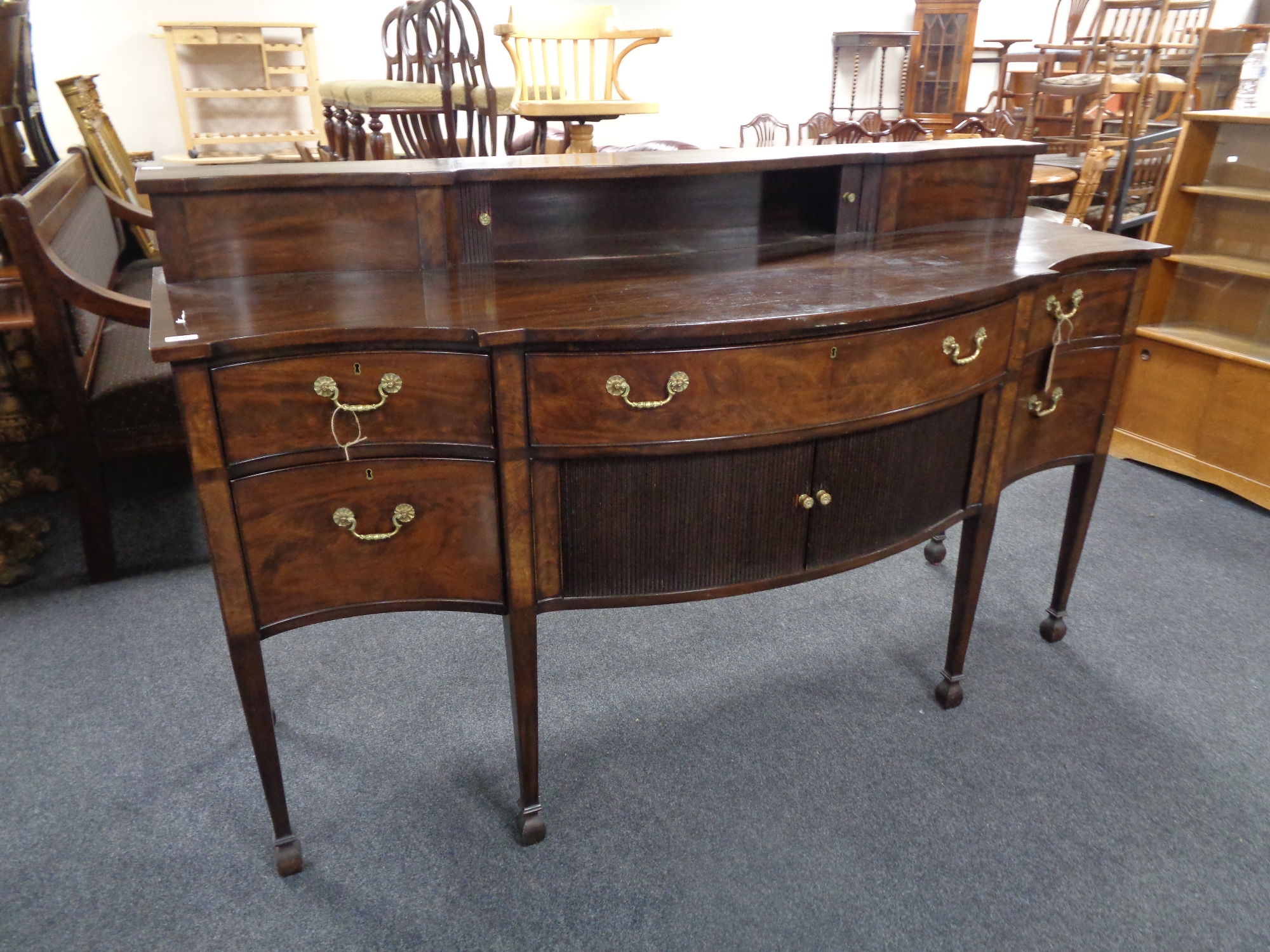 A George III style mahogany serpentine front sideboard,