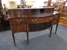 A George III style mahogany serpentine front sideboard,