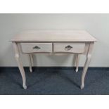 A contemporary two drawer console table in a washed pine finish.