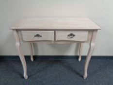 A contemporary two drawer console table in a washed pine finish.