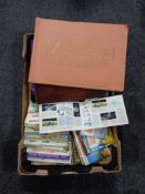 A box containing United Kingdom and German tea cards in albums.