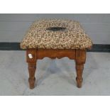 An Edwardian tapestry upholstered foot stool.