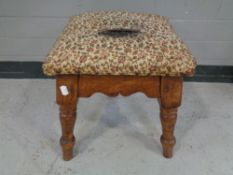 An Edwardian tapestry upholstered foot stool.