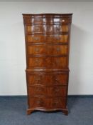 A mahogany Regency style bow fronted eight drawer chest on chest with slide