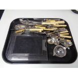 A tray containing assorted stainless steel and plated cutlery servers, plated mustard pot,