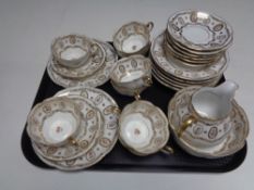 A tray containing a 26 piece hand painted gilded china tea service.