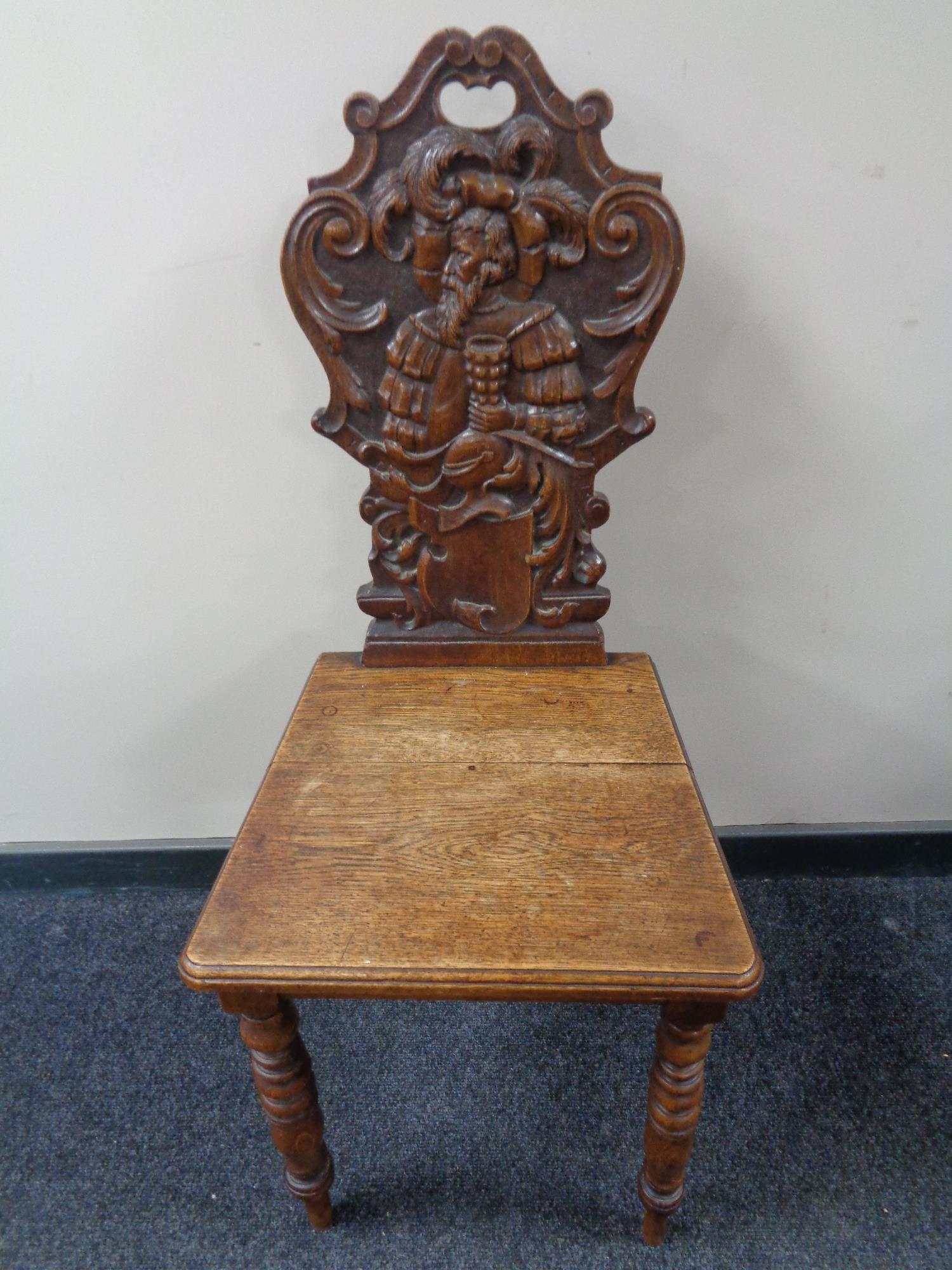 A late nineteenth century carved oak hall chair