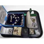 A tray of silver and costume jewellery including locket on chain, enamelled badges,