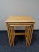 A nest of three pine tables together with a bentwood chair