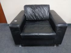 A contemporary black leather armchair