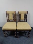 A pair of late nineteenth century carved occasional chairs in golden fabric