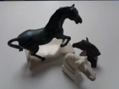 A tray of bronze figure of a horse on marble plinth and two further horse head ornaments