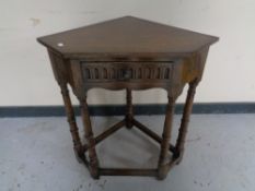 A twentieth century oak corner table fitted a drawer