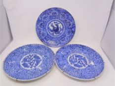 A pair of 19th century Chinese glazed blue and white wall plates depicting dragons, width 31 cm,