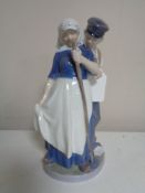 A Royal Copenhagen figure number 1300 - couple in traditional Dutch clothing carrying tools