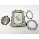 Three silver photograph frames, plus one other frame.