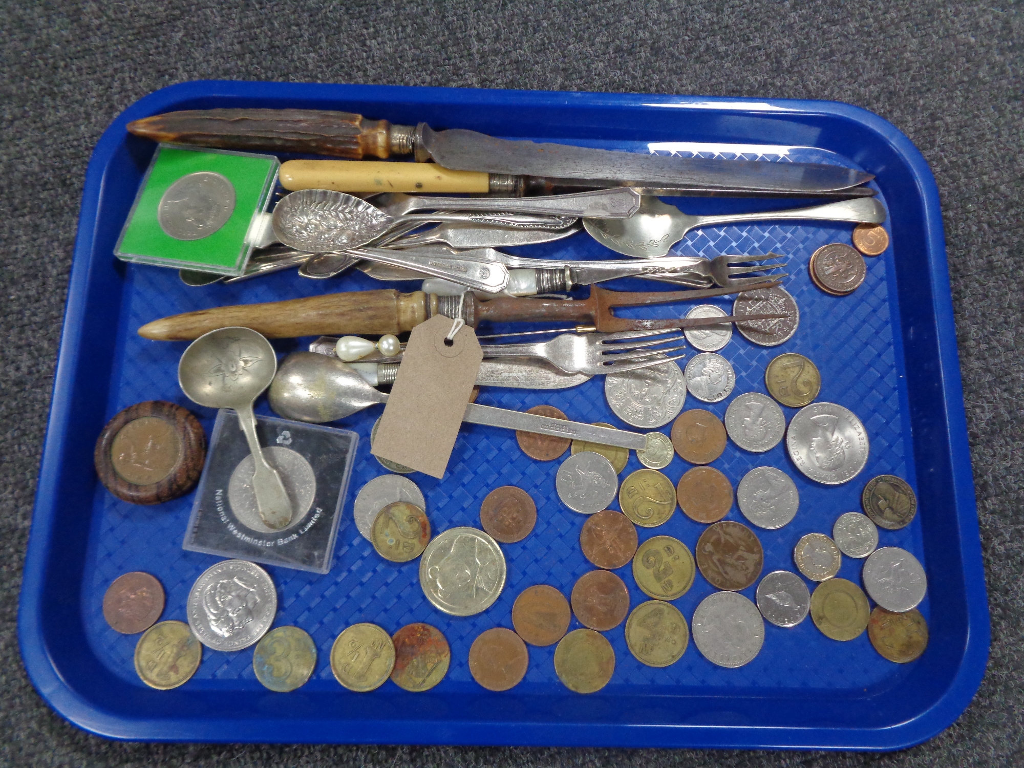 A tray of assorted plated cutlery and servers, foreign coins,