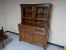 A twentieth century oak double door sideboard fitted with two drawers and cupboards