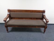 A stained pine pub bench upholstered in fabric