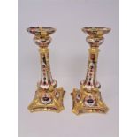 A pair of Royal Crown Derby Imari patterned candlesticks, number 1128, height 26.