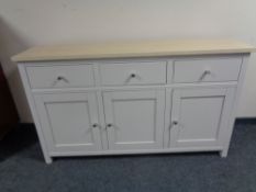 A Contemporary painted triple drawer sideboard with pine top