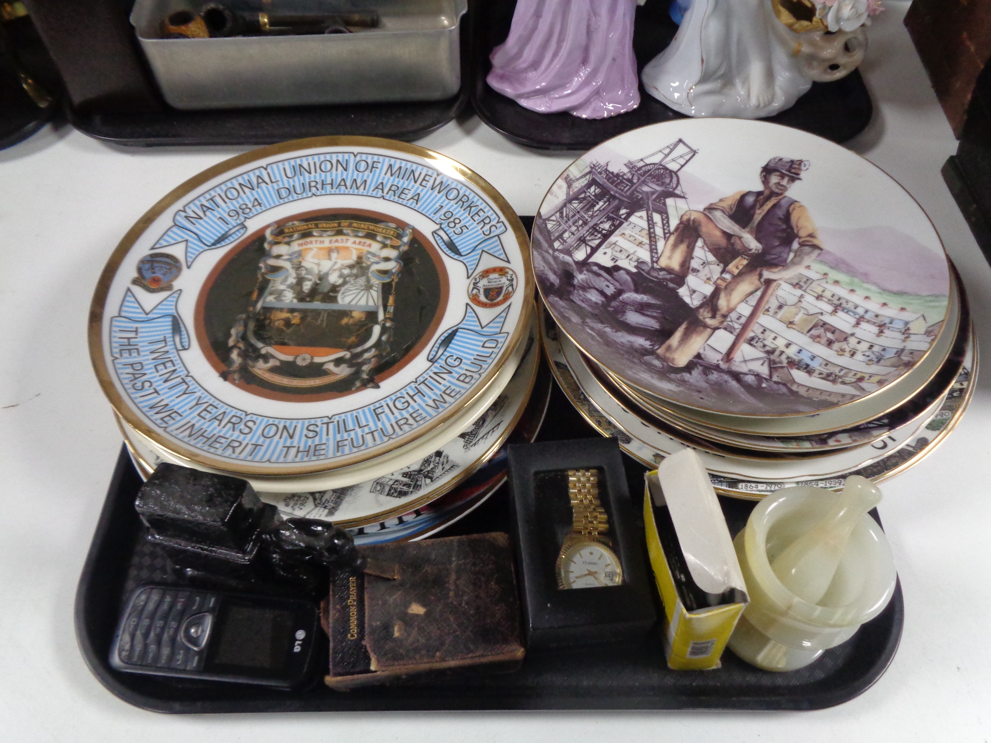A tray of a quantity of assorted plates relating to mining, mobile phone, gent's wristwatch,