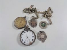 A collection of silver to include pocket watch, fob watch,